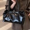 Vintage Leather Shoulder BagElevate your everyday look with sleek urban simplicity. Crafted in premium coffee-toned PU leather with a structured horizontal silhouette. Features a secure lock closure, built-in center divider, and double straps for effortless style.