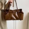 Vintage Leather Shoulder BagElevate your everyday look with sleek urban simplicity. Crafted in premium coffee-toned PU leather with a structured horizontal silhouette. Features a secure lock closure, built-in center divider, and double straps for effortless style.