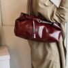Vintage Leather Shoulder BagElevate your everyday look with sleek urban simplicity. Crafted in premium coffee-toned PU leather with a structured horizontal silhouette. Features a secure lock closure, built-in center divider, and double straps for effortless style.